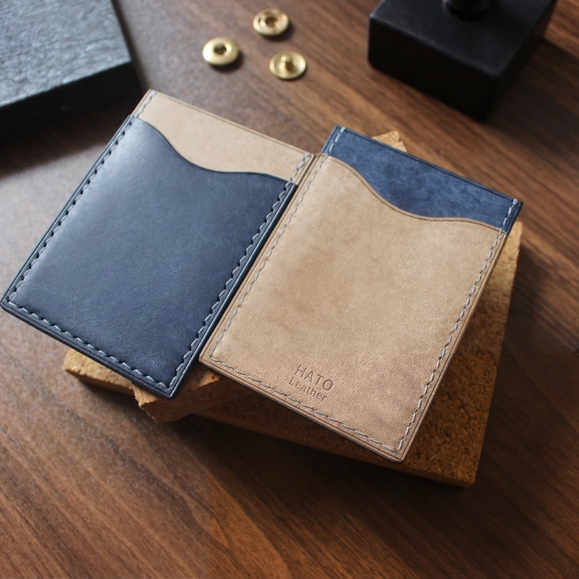 Hato Leather 直款皮革卡套，深藍色與灰色雙色拼接設計，展示精緻手縫線工藝與品牌 Logo 壓印細節